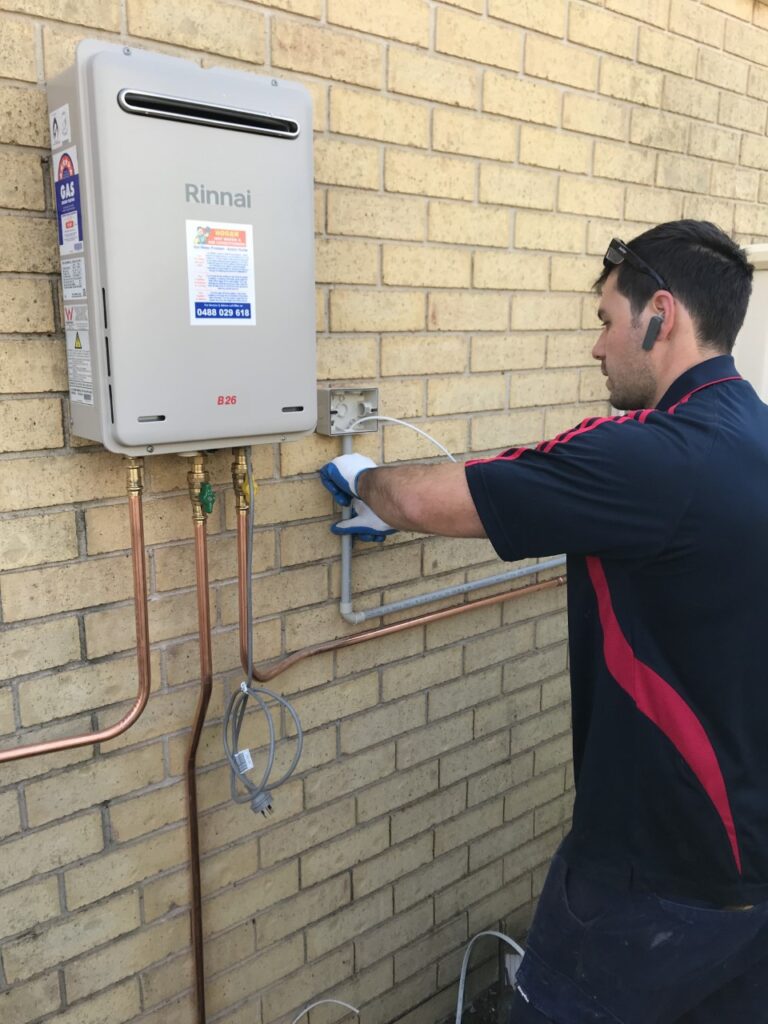 Rinnai » A technician from Hogan Hot Water performing an installation on a Rinnai B26 continuous flow gas hot water system.
