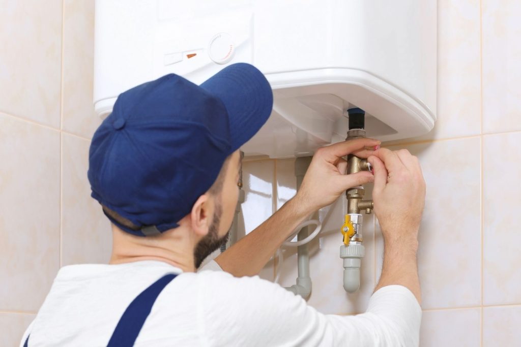 Plumber Repairing a Water Heater