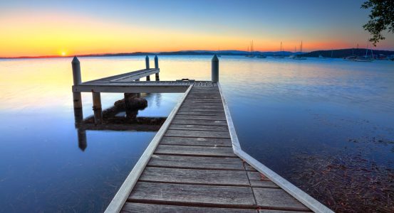 A wooden jetty extending into a calm lake in Belmont