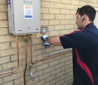 Rinnai continuous natural gas water heater A technician from Hogan Hot Water performing an installation on a Rinnai B26 continuous flow gas hot water system.